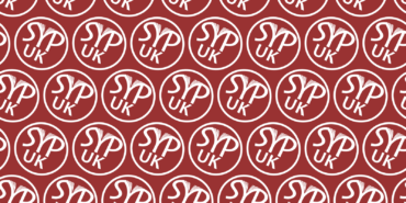 A dark red background featuring a repeating pattern of the white SYP UK roundel.